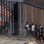 Migrants at a border crossing of the southern US border near Tijuana, Mexico, in 2018. Photo: Guillermo Arias/AFP.