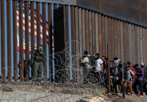 Migrants at a border crossing of the southern US border near Tijuana, Mexico, in 2018. Photo: Guillermo Arias/AFP.