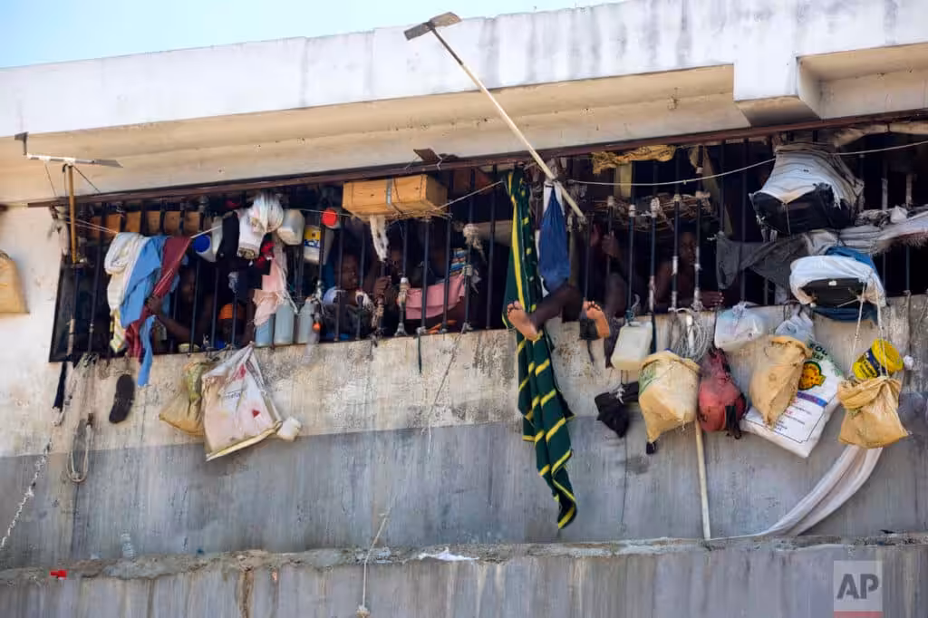 Prisoners look out from between bars at the National Penitentiary in Port-au-Prince, Haiti. Photo: Dieu Nalio Chery