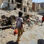 Children walk through a damaged part of downtown Craiter in Aden, Yemen. The area was badly damaged by airstrikes in 2015 as the Houthi’s were driven out of the city by coalition forces. Photo: Giles Clarke/OCHA.