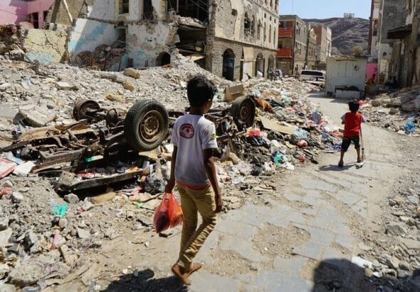 Children walk through a damaged part of downtown Craiter in Aden, Yemen. The area was badly damaged by airstrikes in 2015 as the Houthi’s were driven out of the city by coalition forces. Photo: Giles Clarke/OCHA.