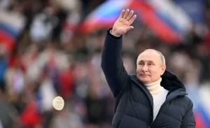 Russian President Vladimir Putin waves during a concert marking the eighth anniversary of Russia's annexation of Crimea at the Luzhniki stadium in Moscow on March 18, 2022. Photo: Ramil Sitdikov/POOL/AFP—Getty Images.