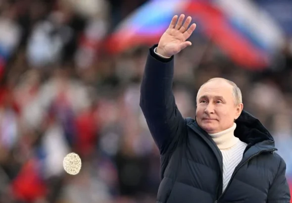Russian President Vladimir Putin waves during a concert marking the eighth anniversary of Russia's annexation of Crimea at the Luzhniki stadium in Moscow on March 18, 2022. Photo: Ramil Sitdikov/POOL/AFP—Getty Images.