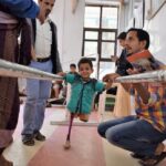 A boy learning to walk with a prostheses after losing his two legs as a result of the cruel war against the Yemeni people. Photo: Qusai/LMOAYED/ICRC.