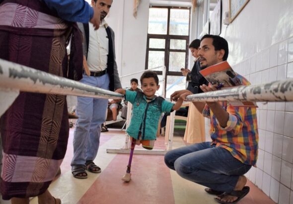 A boy learning to walk with a prostheses after losing his two legs as a result of the cruel war against the Yemeni people. Photo: Qusai/LMOAYED/ICRC.