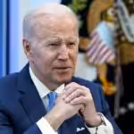 President Biden seated with hands clasped. File photo.