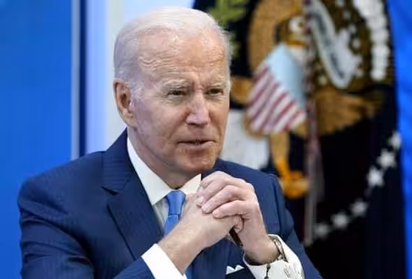 President Biden seated with hands clasped. File photo.