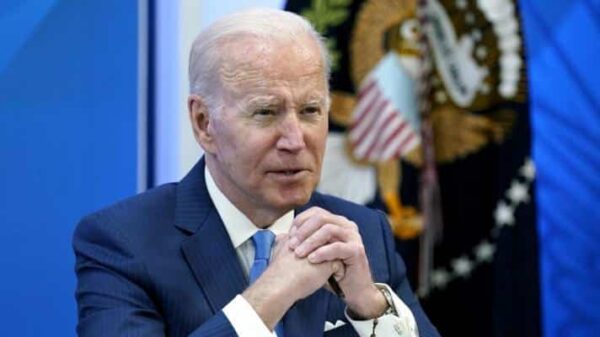 President Biden seated with hands clasped. File photo.
