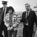 Leonard Peltier, American Indian Movement leader, is led across Oakalla Prison to a waiting helicopter, on Dec. 17, 1976, in Burnaby, British Columbia. Photo: Bettmann Archive.