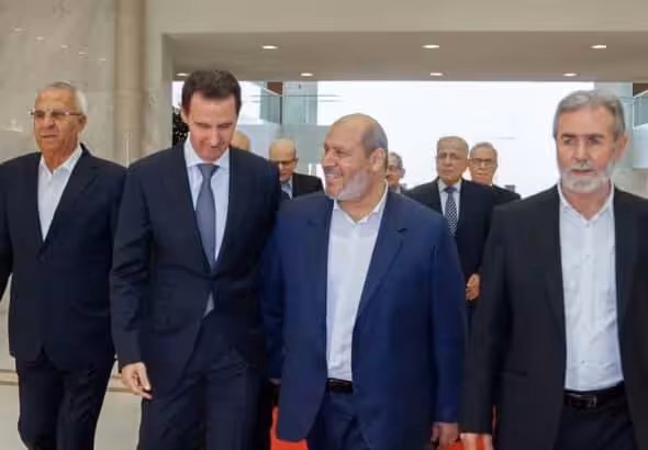 Syrian President Bashar al-Assad walks next to Khalil al-Hayya, Hamas politburo member, during the most recent Hamas visit to Damascus last Wednesday, October 19, 2022. Photo Syria News.