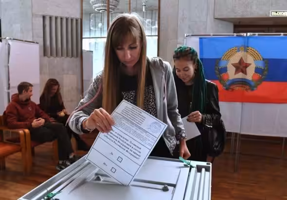 A girl votes in a referendum on the accession of the Luhansk People's Republic to Russia at a polling station. Photo: Sputnik/Evgeny Biyatov.