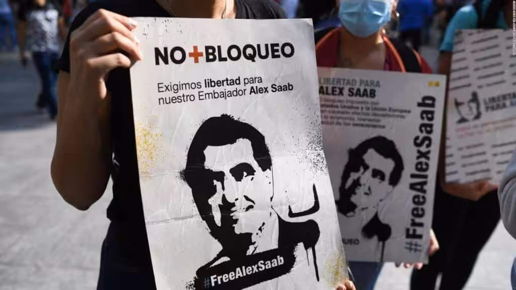 Protesters hold signs denouncing illegal US detention of Venezuelan diplomat Alex Saab. File Photo.