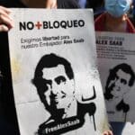 Protesters hold signs denouncing illegal US detention of Venezuelan diplomat Alex Saab. File Photo.