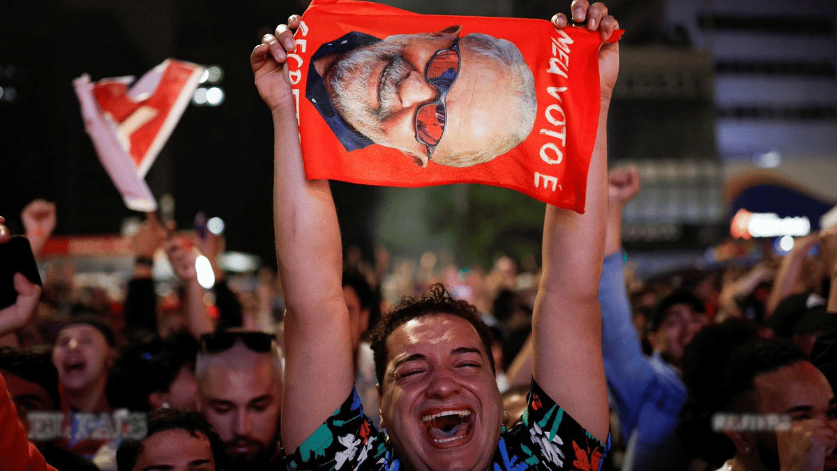 Lula supporter crying with joy while holding a big photo of Lula during a political rally. Photo: Reuters.