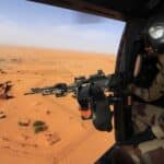 (2014) A French military helicopter flies over the Nigerien town Madama, which served as a forward operating base for the French, Niger and Chad armies. Photo: Thomas Goisque/Wikimedia.