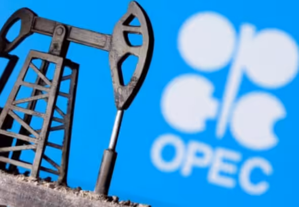 A 3D printed oil pump jack is seen in front of displayed OPEC logo in this illustration picture. File Photo