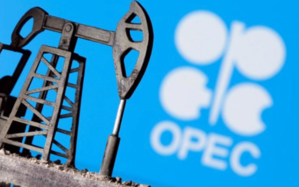 A 3D printed oil pump jack is seen in front of displayed OPEC logo in this illustration picture. File Photo