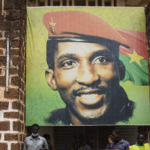 People gather for a wreath laying ceremony in front of the building where Thomas Sankara was assassinated in 1987 in Ouagadougou, Burkina Faso, April 6, 2022, after the verdict of the trial of his assassins. Photo: Sophie Garcia