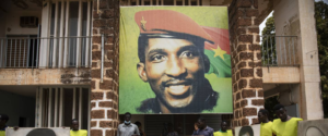 People gather for a wreath laying ceremony in front of the building where Thomas Sankara was assassinated in 1987 in Ouagadougou, Burkina Faso, April 6, 2022, after the verdict of the trial of his assassins. Photo: Sophie Garcia