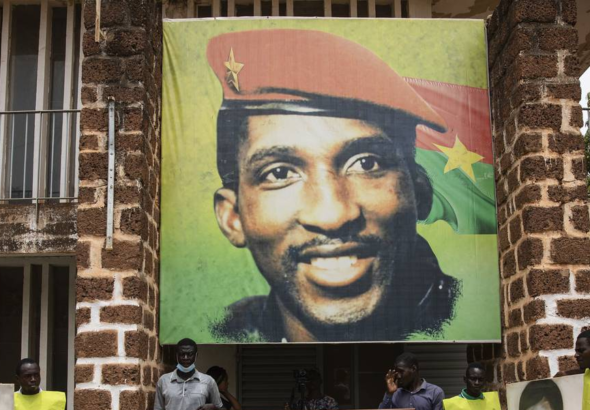 People gather for a wreath laying ceremony in front of the building where Thomas Sankara was assassinated in 1987 in Ouagadougou, Burkina Faso, April 6, 2022, after the verdict of the trial of his assassins. Photo: Sophie Garcia