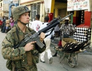 U.S. soldier on patrol in Port-au-Prince on Mar. 15, 2004, during the third U.S. military invasion of Haiti. Photo: Reuters.