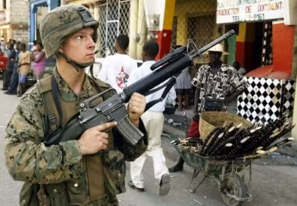 U.S. soldier on patrol in Port-au-Prince on Mar. 15, 2004, during the third U.S. military invasion of Haiti. Photo: Reuters.