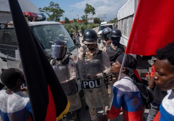 Demonstrators argue with police during a protest in Port-au-Prince. File Photo. 