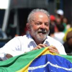 Lula clutches a Brazilian flag after huis victory. Photo: NPR.