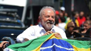 Lula clutches a Brazilian flag after huis victory. Photo: NPR.