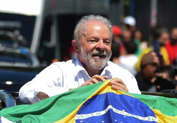 Lula clutches a Brazilian flag after huis victory. Photo: NPR.