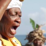 Featured image:  Garifuna woman, from the Tela Bay, singing traditional songs. Photo: Radio Progreso (Honduras).