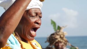Featured image:  Garifuna woman, from the Tela Bay, singing traditional songs. Photo: Radio Progreso (Honduras).