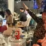 Featured image: A person doing the Nazi salute while being photograph, in front of a birthday cake with Nazi  memorabilia at the Salvaje restaurant in Las Mercedes, Caracas. Photo: Ultimas Noticias.
