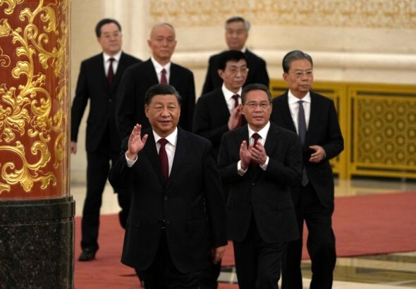 New members of the Communist Party of China's Politburo Standing Committee arrive at the Great Hall of the People in Beijing on Sunday. Photo: Ng Han Guan/AP.