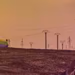 A tank carrying a US flag colored with the LGBTQ+ rainbow, patrolying near an oil rig in a dessert area. Photo: Rainer Shea.
