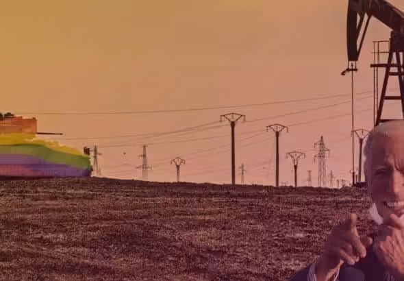 A tank carrying a US flag colored with the LGBTQ+ rainbow, patrolying near an oil rig in a dessert area. Photo: Rainer Shea.