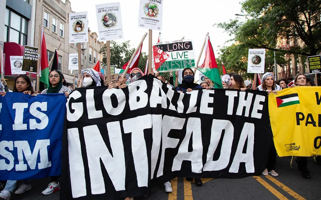 People marching with banners, one reads: "Globalize the Intifada." Photo: Palestinian Alternative Revolutionary Path Movement.