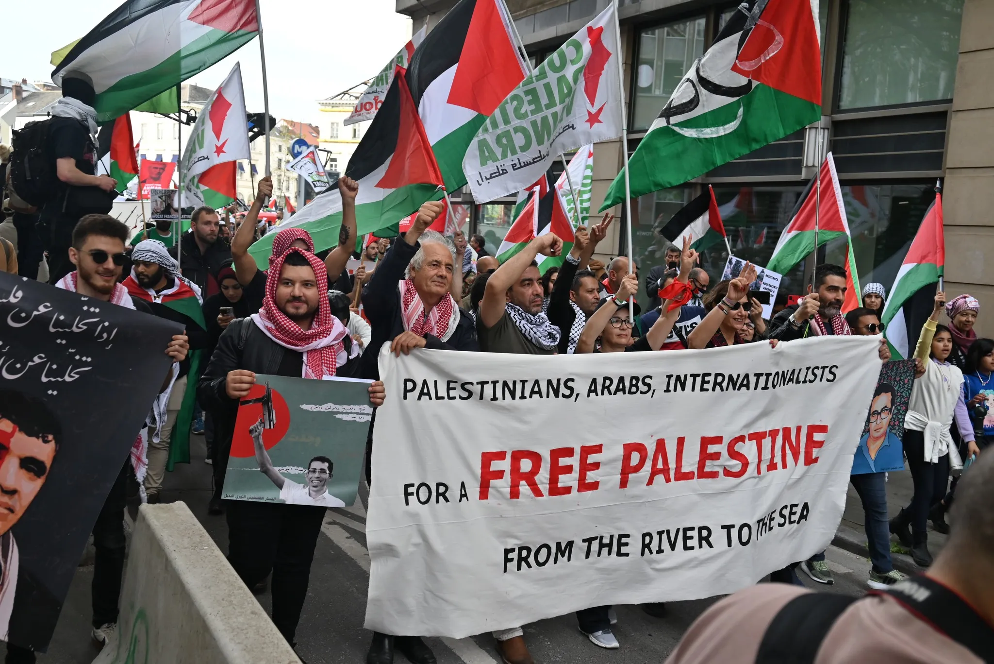People marching and holding a sign that says "Free Palestine". Photo: Samidoun.