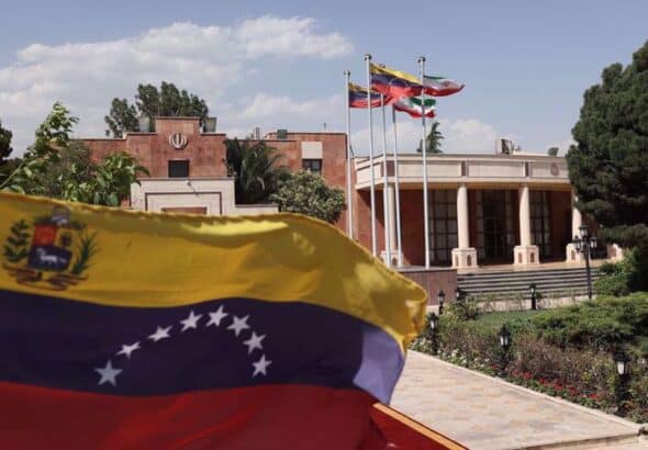 The flags of Iran and Venezuela are seen when Venezuelan President Nicolas Maduro arrives at Mehrabad Airport in Tehran, June 10, 2022. Photo by Reuters.
