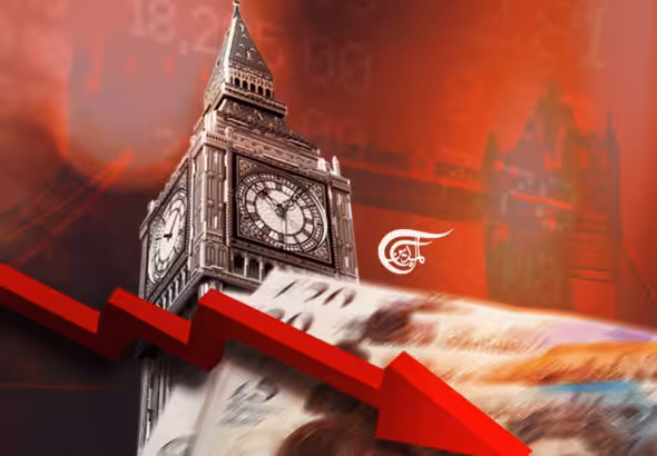 Photo composition with the Big Ben Tower in the center and the London Bridge in the background, with a red pointing down arrow as a reference to UK's poor economic performance. Photo: Al Mayadeen – English.