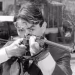 Atticus Finch from To Kill a Mockingbird holding a rifle. Photo: Scott Ritter Extra. 