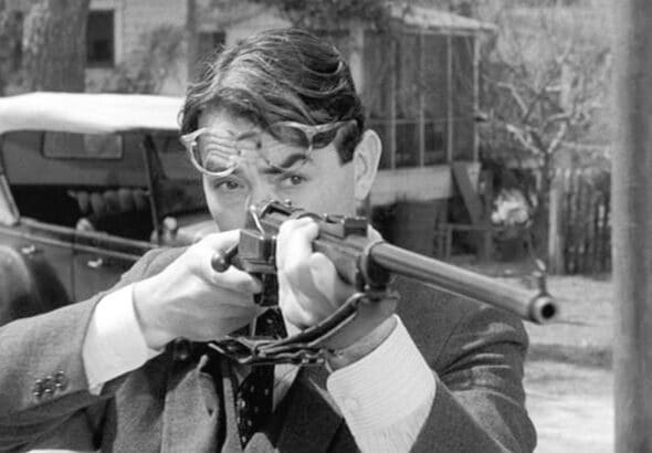 Atticus Finch from To Kill a Mockingbird holding a rifle. Photo: Scott Ritter Extra. 