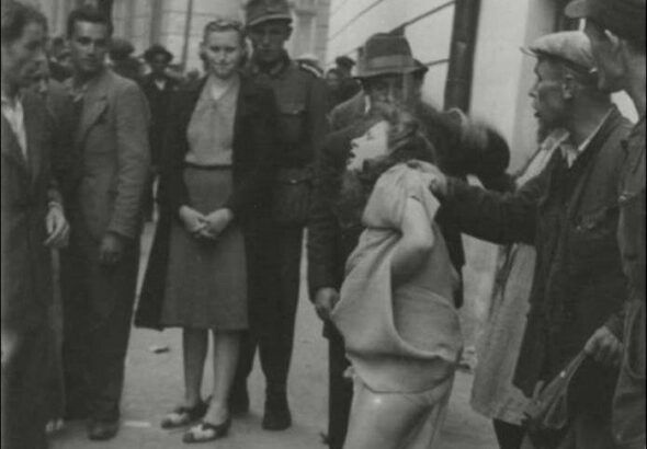 A woman is attacked during 1941 pogrom in Ukraine. File photo.