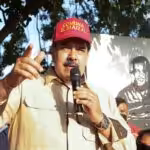 Venezuelan President Nicolas Maduro during a recent visit to El Maizal commune, Lara state, with a drawing of Hugo Chávez behind him. Photo: Presidential Press.