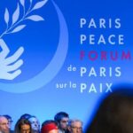 A banner reading "Paris Peace Forum, de Paris sur la paix," displayed at the forum. File photo.