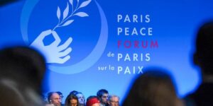 A banner reading "Paris Peace Forum, de Paris sur la paix," displayed at the forum. File photo.