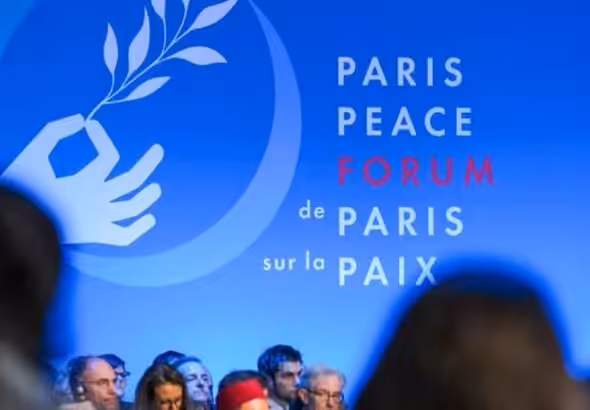 A banner reading "Paris Peace Forum, de Paris sur la paix," displayed at the forum. File photo.