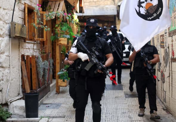 Members of the Lions' Den during a memorial service for Mahmoud al-Azizi and Aboud Suboh who were killed by Israeli forces in the Palestinian city of Nablus. Photo: Shadi Jararah/APA Images.