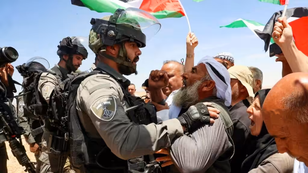 Israeli soldiers confront Palestinians in Masafer Yatta protesting against a court order that allows the Israeli occupation to demolish Palestinian homes to build illegal settlements. Photo: AFP/Hazem Bardel.
