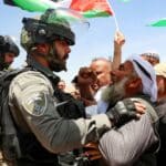 Israeli soldiers confront Palestinians in Masafer Yatta protesting against a court order that allows the Israeli occupation to demolish Palestinian homes to build illegal settlements. Photo: AFP/Hazem Bardel.